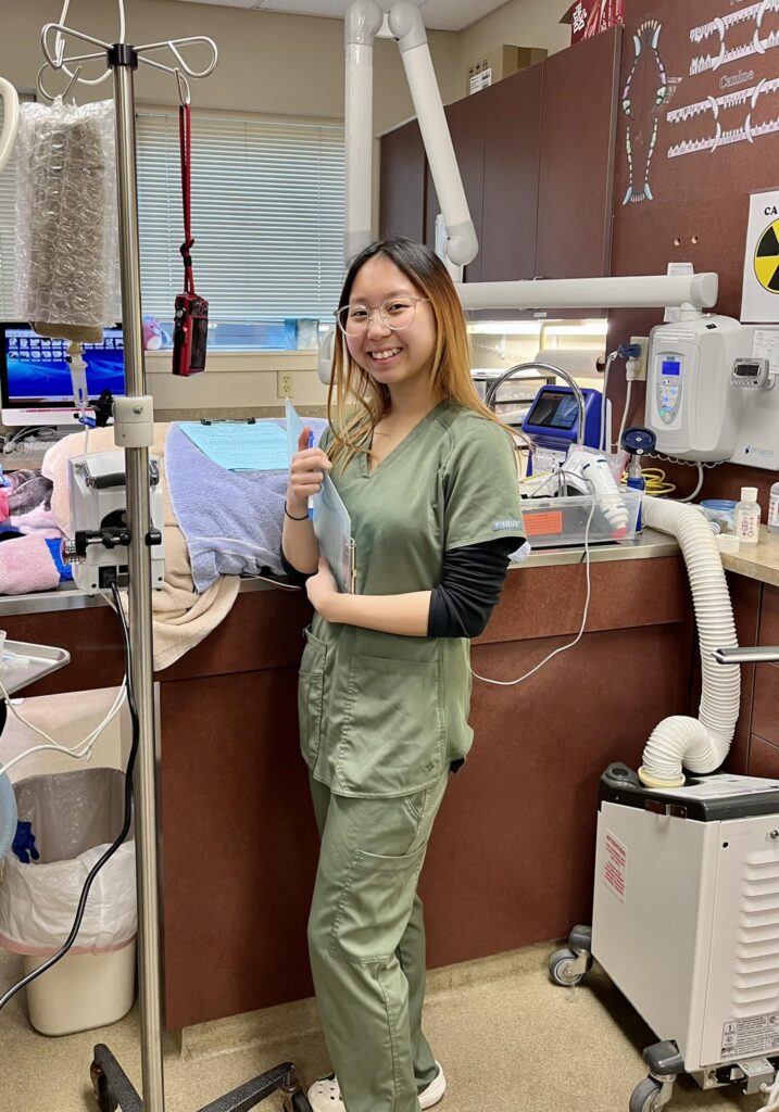 Woman smiling standing next to surgery equipment