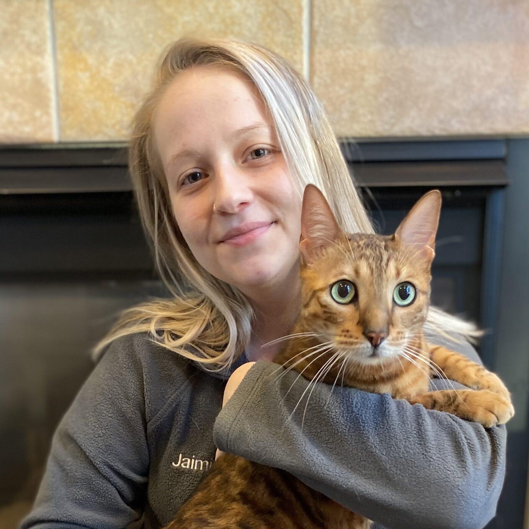 woman holding an orange cat