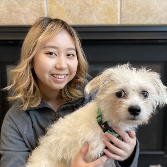 woman holding a cute small dog