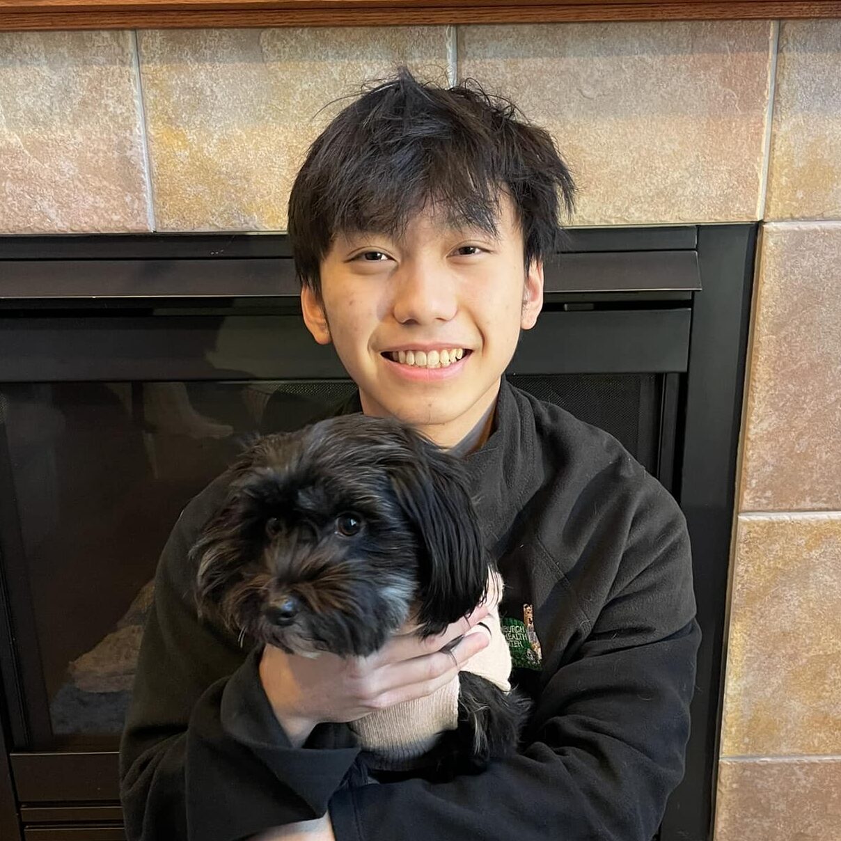 man smiling and holding a dog