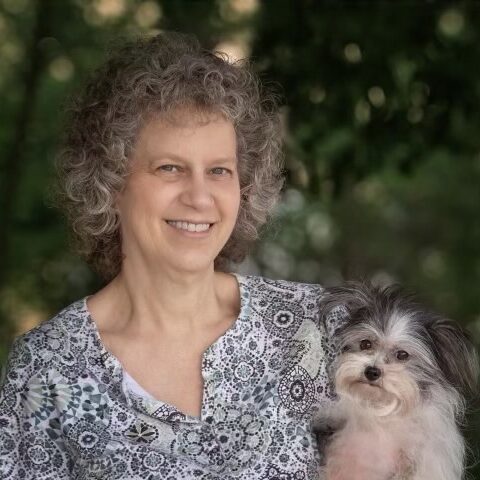 woman smiling with her small dog