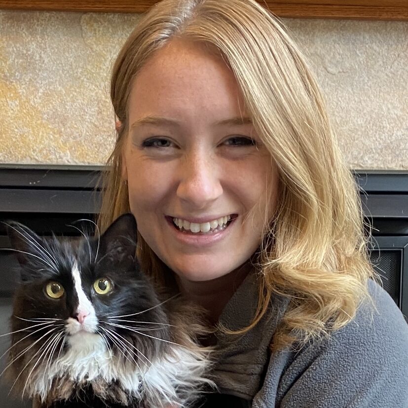 woman smiling and holding a cat